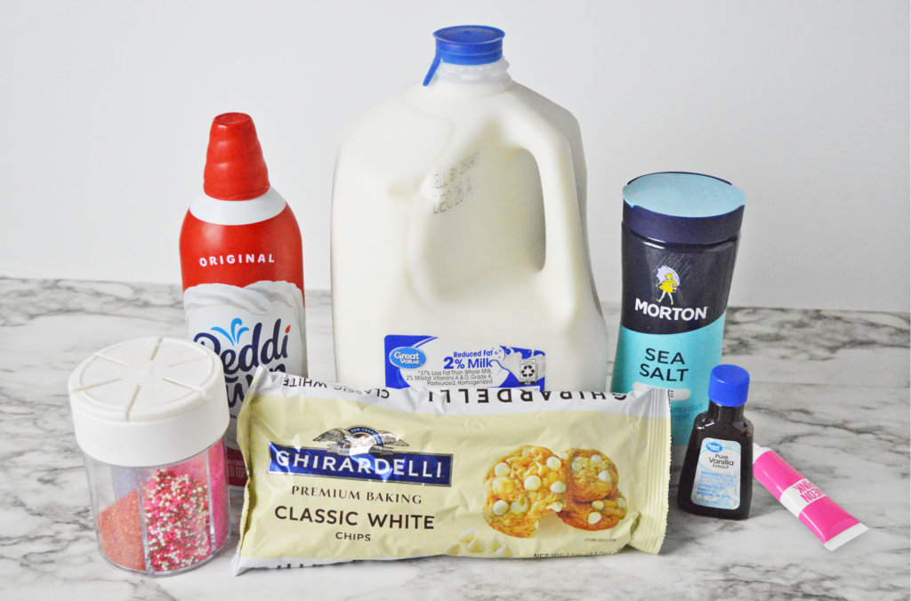 Valentines Hot Chocolate ingredients- milk, white chocolate, salt, vanilla, pink gel food coloring, whipped cream, and sprinkles