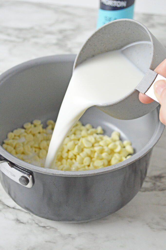 milk pouring over the white chocolate chips
