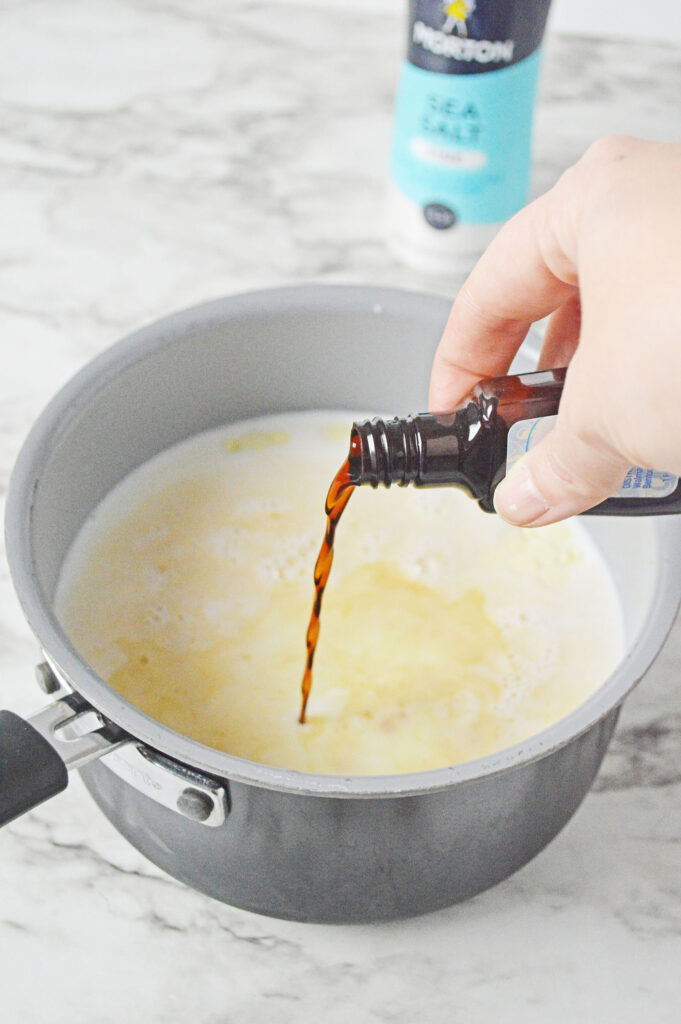 vanilla pouring into the sauce pan