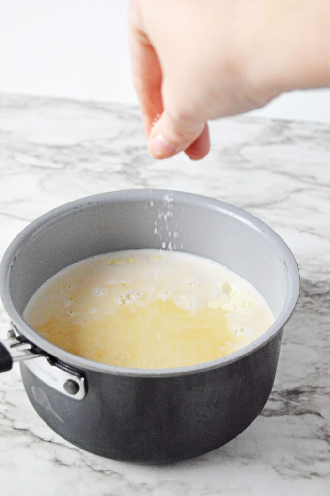 sprinkling salt into the sauce pan