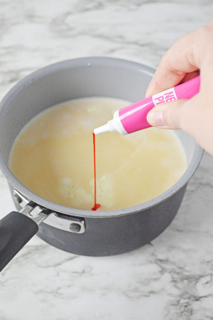 adding pink food coloring to the mixture