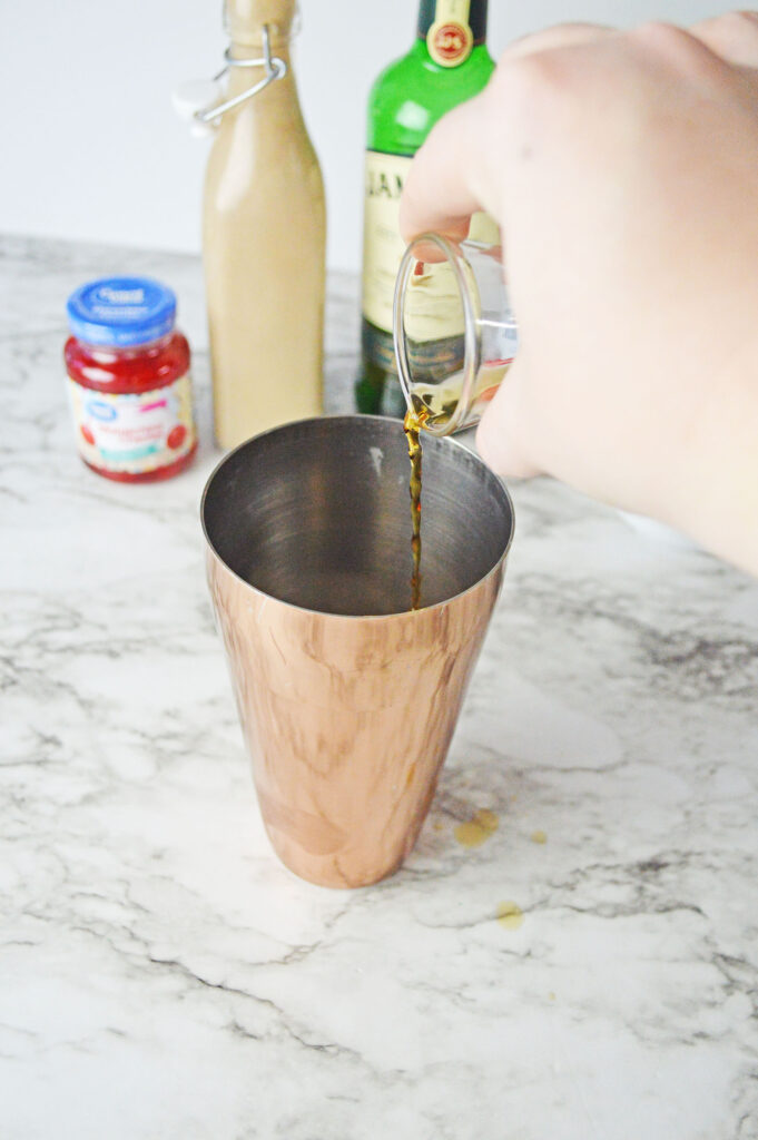 coffee pouring into a cocktail shaker
