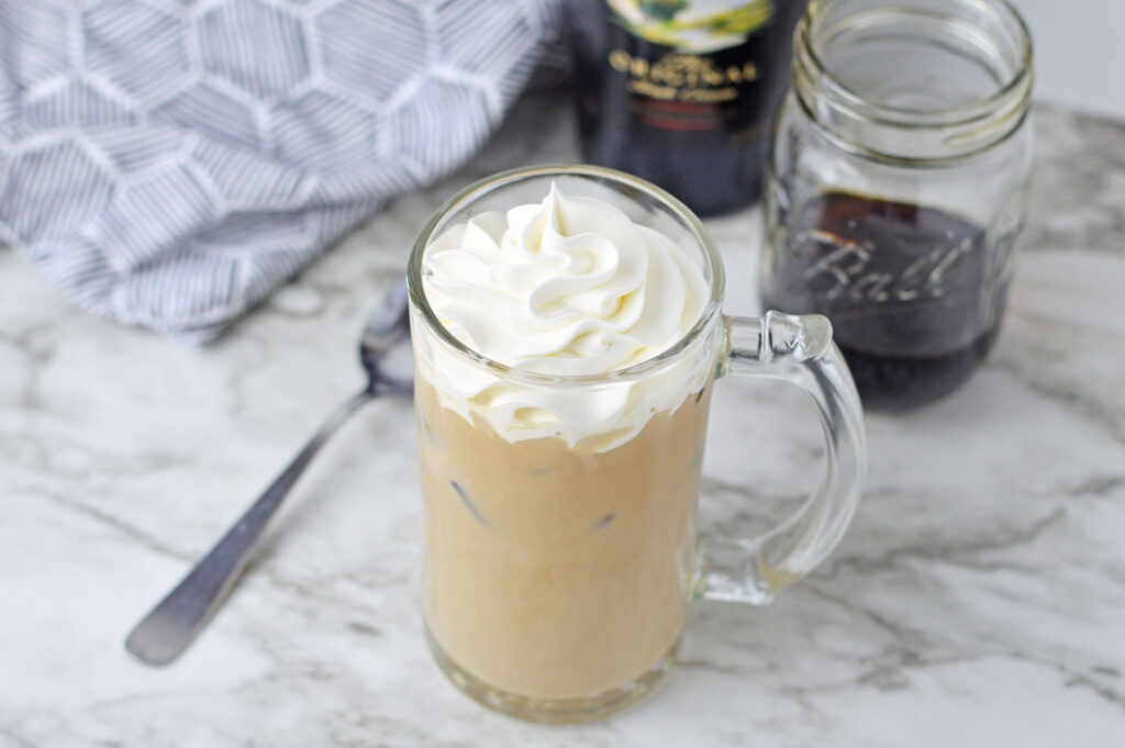iced coffee in a large mug with whipped cream on top