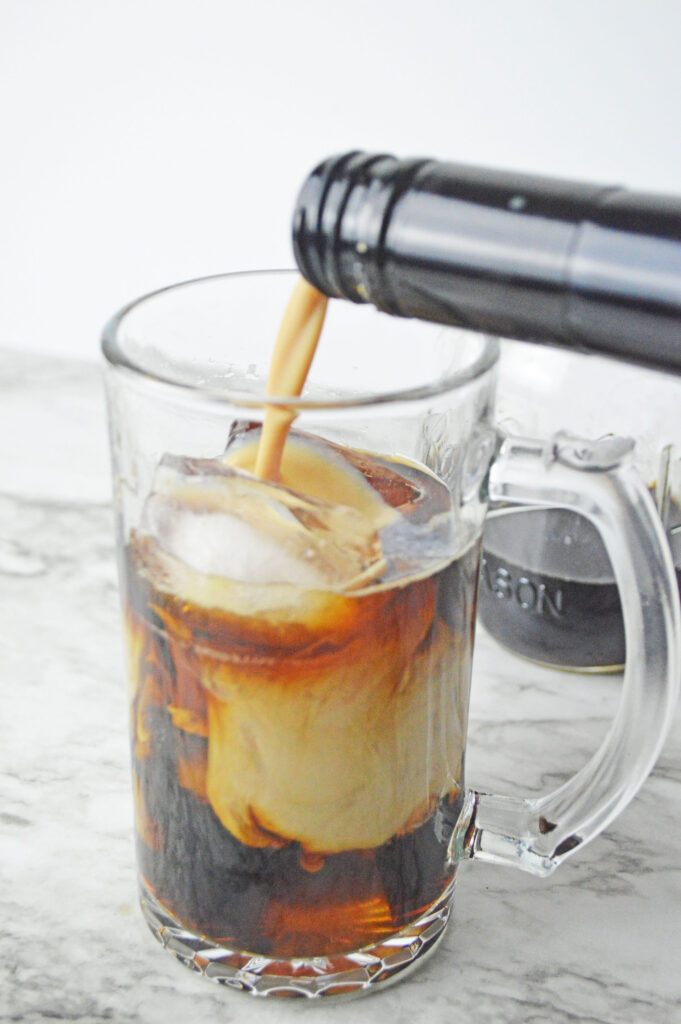 baileys pouring into coffee over ice