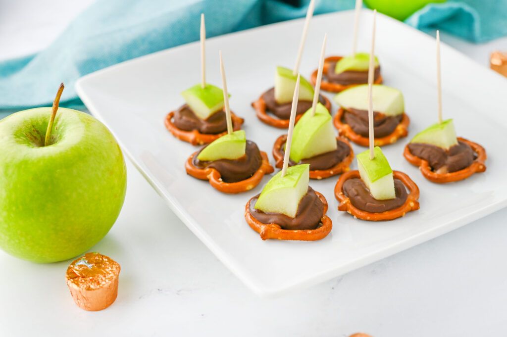 Caramel Apple Bites - pretzels topped with Rolo candies, melted, and topped with a granny smith apple chunk