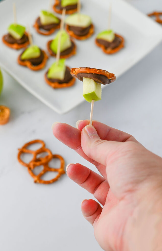 Caramel Apple Bites - pretzels topped with Rolo candies, melted, and topped with a granny smith apple chunk