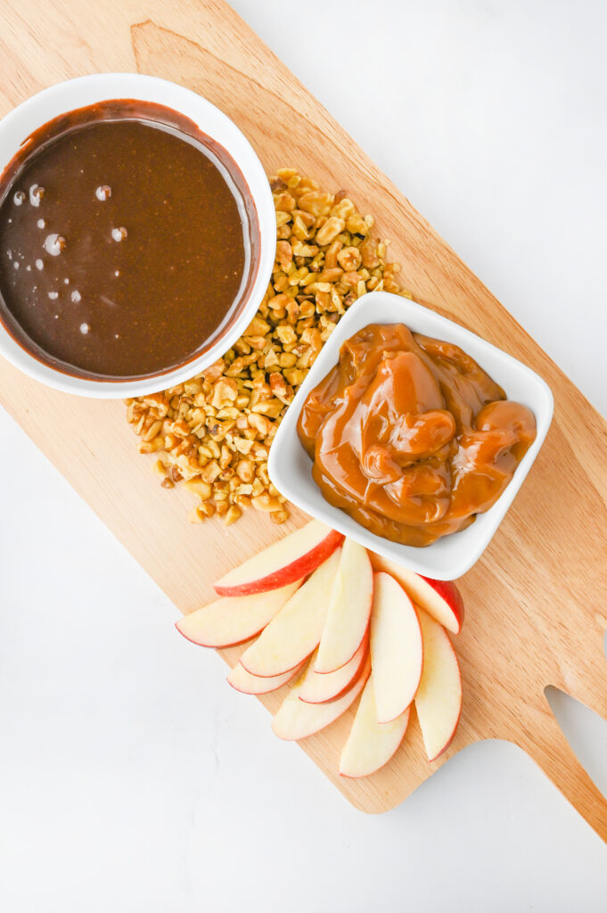 sliced red apples and nuts added to the board