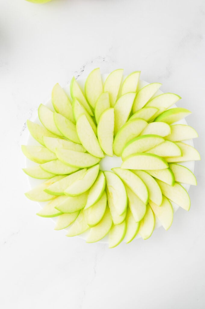 granny smith apples fanned out on a plate