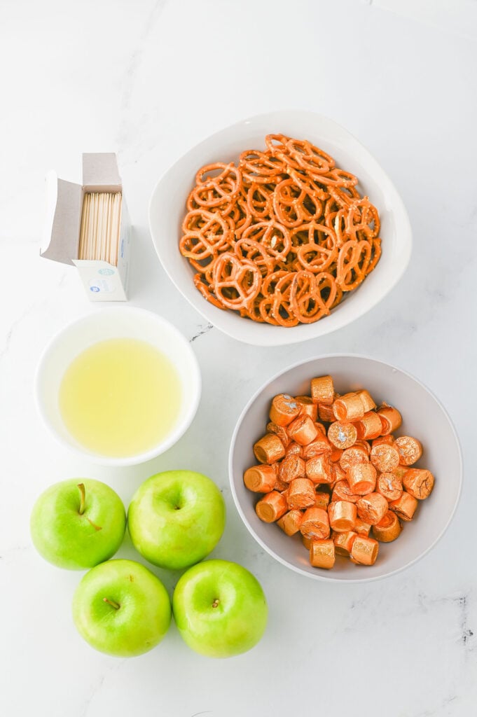 Caramel apple bites ingredients- pretzels, Rolo candies, granny smith apples, lime juice, and tooth picks