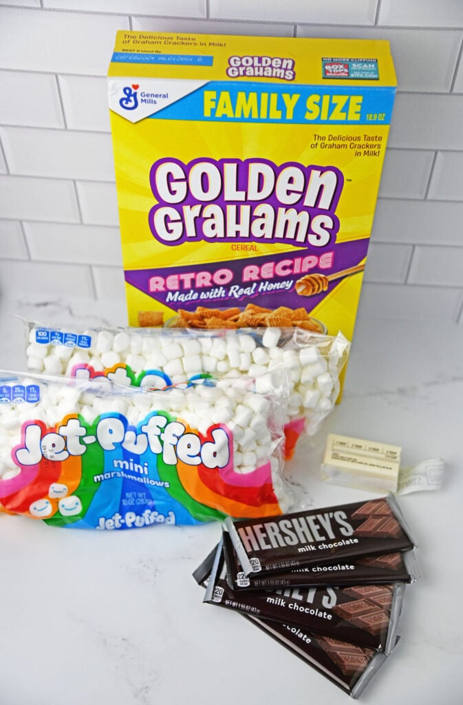 Golden Grahams S'mores Bars ingredients- golden grahams, mini marshmallows, butter, and hershey bars