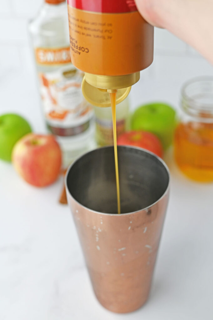 caramel drizzling into a shaker cup