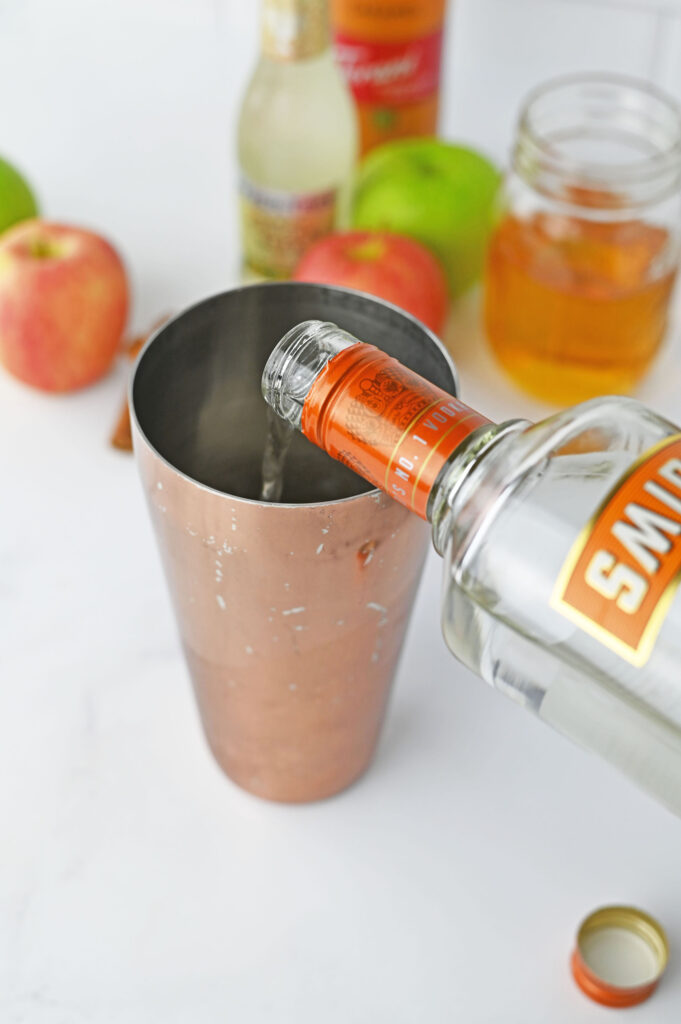 smirnoff kissed caramel vodka pouring into a shaker cup