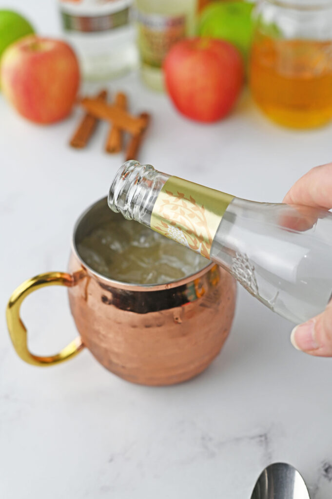 ginger beer pouring into a copper mug
