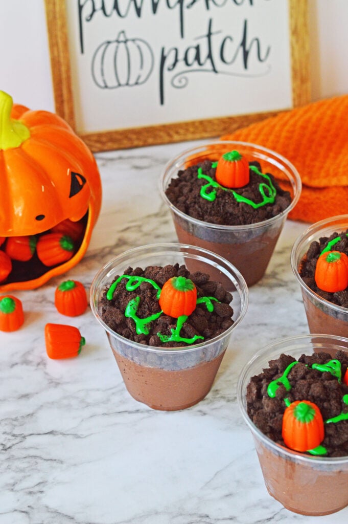 pumpkin patch pudding cups on a table with halloween and fall decor