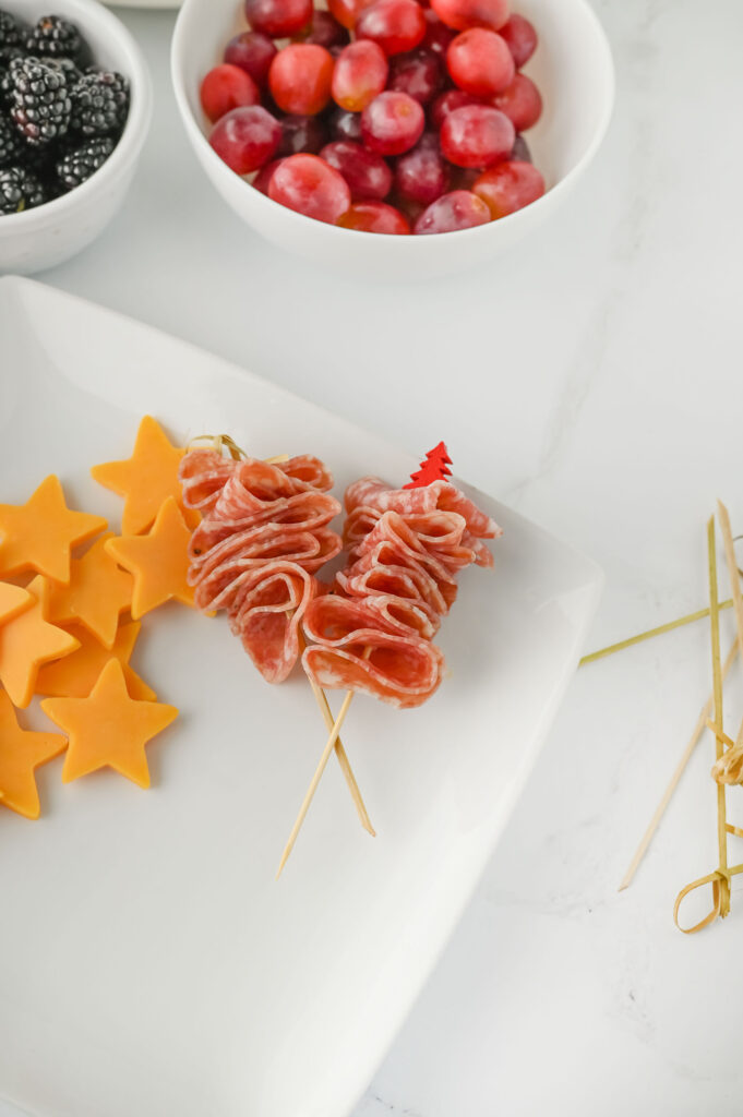 Salami triangles skewered onto Christmas picks