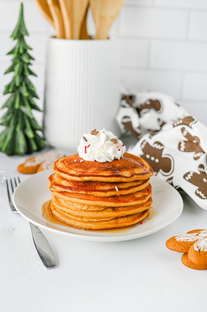 Fluffy homemade gingerbread pancakes stacked on a plate for a festive Christmas breakfast.