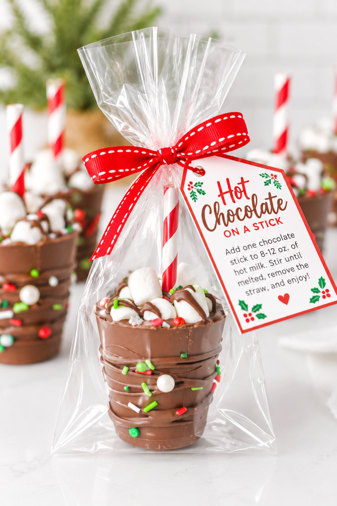 Homemade hot chocolate stick wrapped in clear cellophane with a festive Christmas gift tag