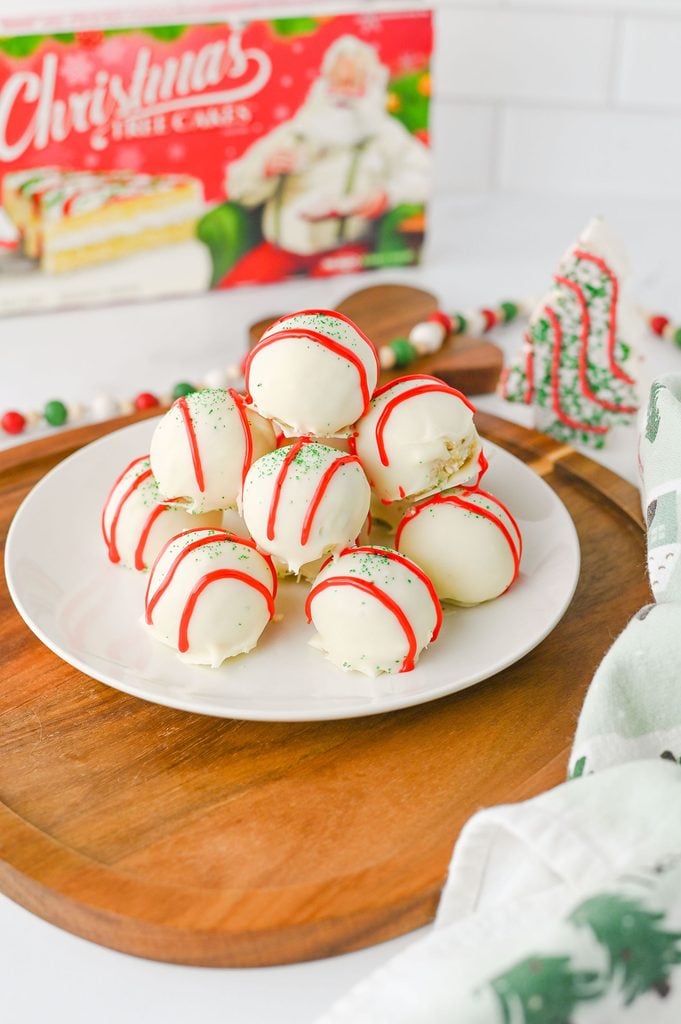Little Debbie Christmas Tree Cake Truffles coated in white chocolate with red icing and green sanding sugar.