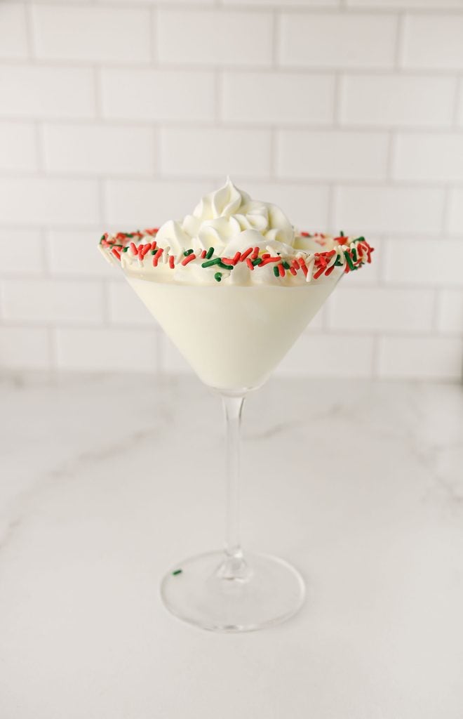Christmas Tree Cake martini topped with whipped cream.