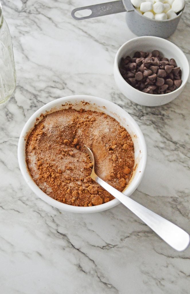 Cocoa powder, granulated sugar, and salt combined in a bowl for homemade hot chocolate mix