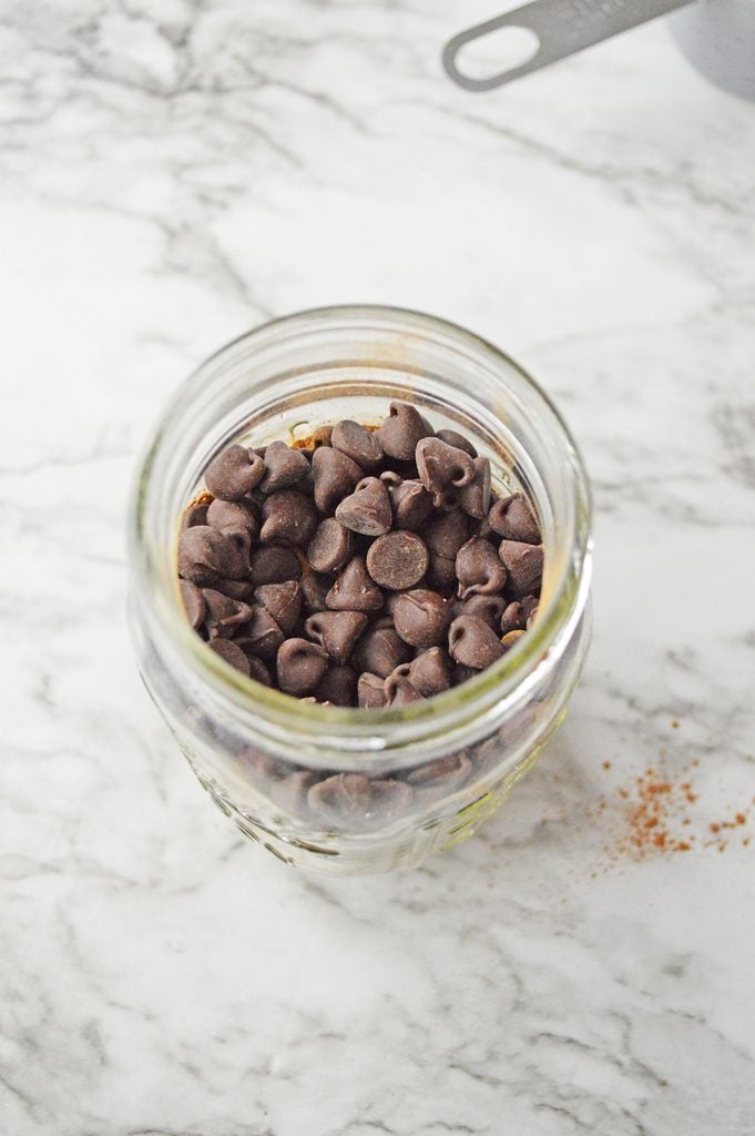 Semi-sweet chocolate chips layered over cocoa mix in a mason jar
