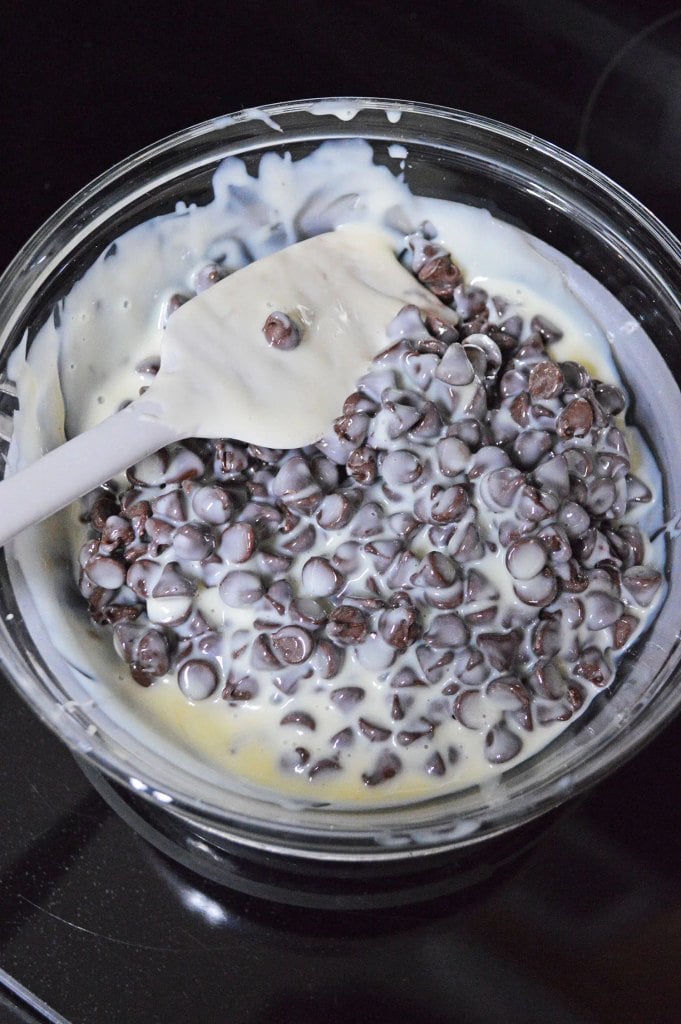 Chocolate chips melting together with sweetened condensed milk for homemade fudge.