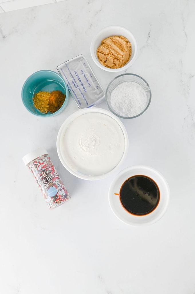 Ingredients for gingerbread dip including cream cheese, brown sugar, powdered sugar, molasses, spices, and Cool Whip