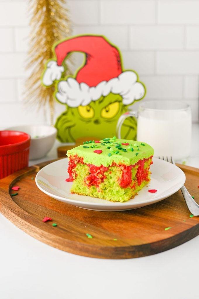 Grinch-themed Christmas dessert with moist green cake, creamy red filling, and heart sprinkles.