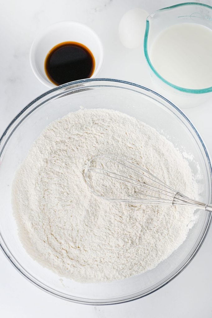 Dry ingredients for Grinch pancakes combined in a large mixing bowl.