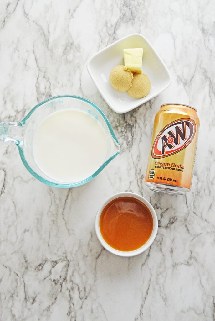 Ingredients for homemade hot butterbeer including milk, brown sugar, butter, cream soda, and butterscotch sauce.