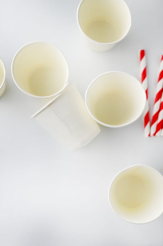 Small paper cups prepared for making homemade hot chocolate sticks