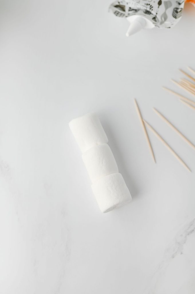 Three jumbo marshmallows connected with toothpicks to make a snowman