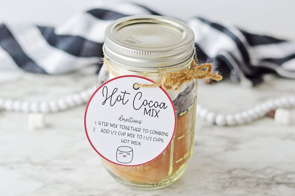 Homemade hot chocolate mason jar gift with layers of cocoa, chocolate chips, and mini marshmallows