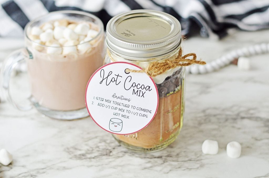 Finished hot cocoa in a jar Christmas gift with a printable gift tag tied on with twine