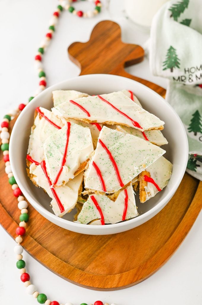 Homemade Christmas Tree Cake Crack topped with white chocolate, red icing stripes, and green sanding sugar.