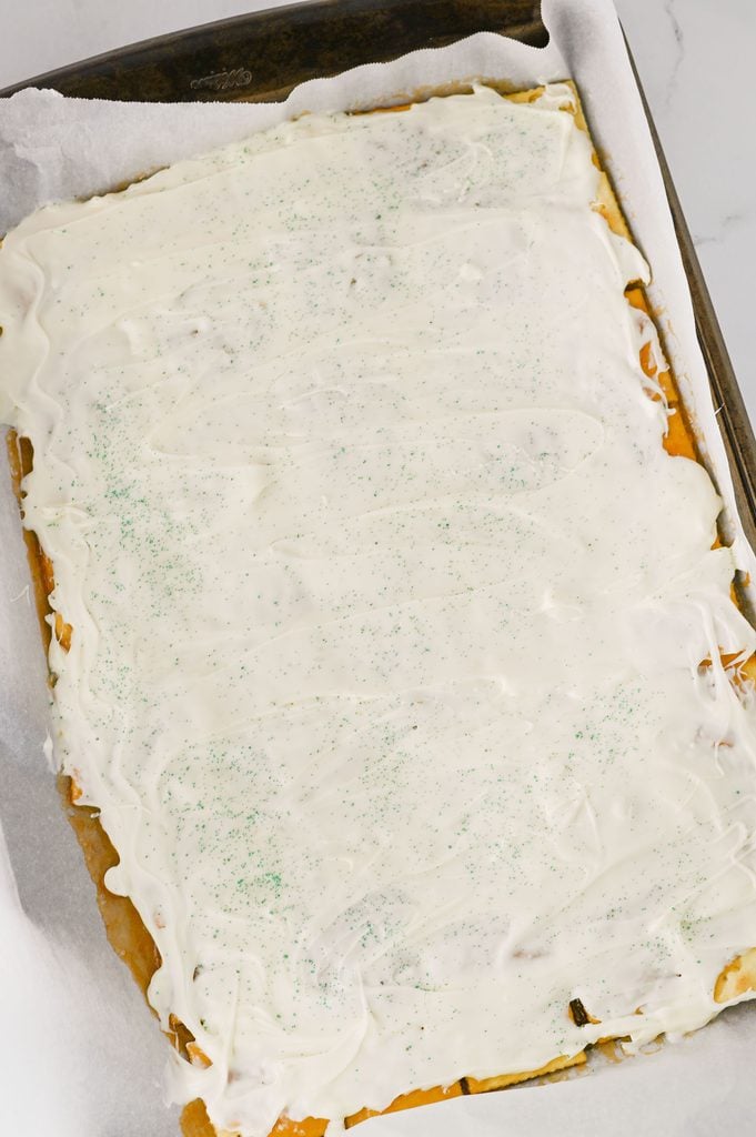 Green sanding sugar sprinkled over white chocolate Christmas crack.